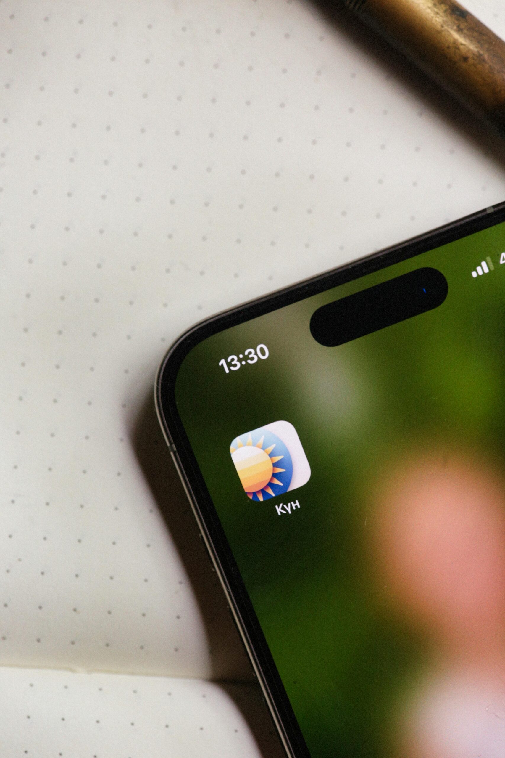 Close-up of a smartphone screen displaying a weather app icon. Ideal for tech-related themes.
